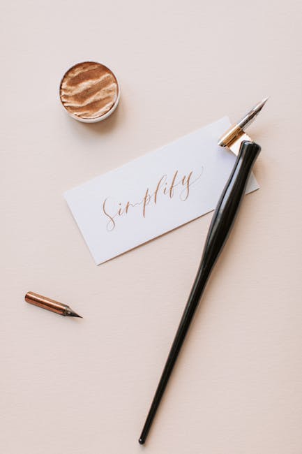 Flat lay of calligraphy tools with a handwritten “Simplify” note on cream background.